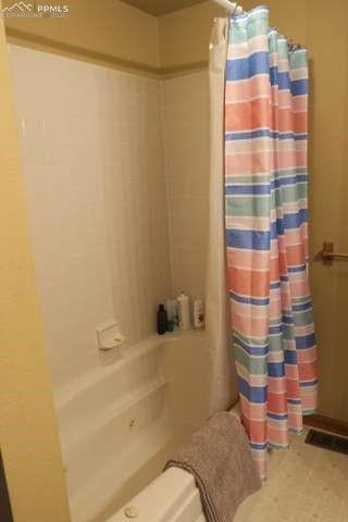 143 Ring Road Guffey, CO 80820 - Photo 15 of 36 Bathroom (in primary) featuring shower / bath combo with shower curtain