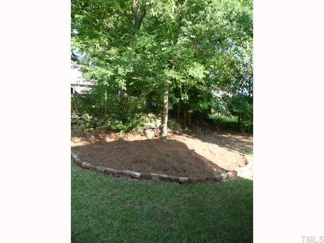 310 Cooke Street Raleigh, NC 27601 - Photo 11 of 12 a view of a yard with plants and a bench