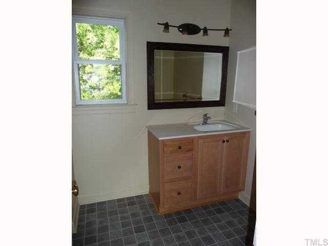 310 Cooke Street Raleigh, NC 27601 - Photo 8 of 12 a bathroom with a sink and a mirror