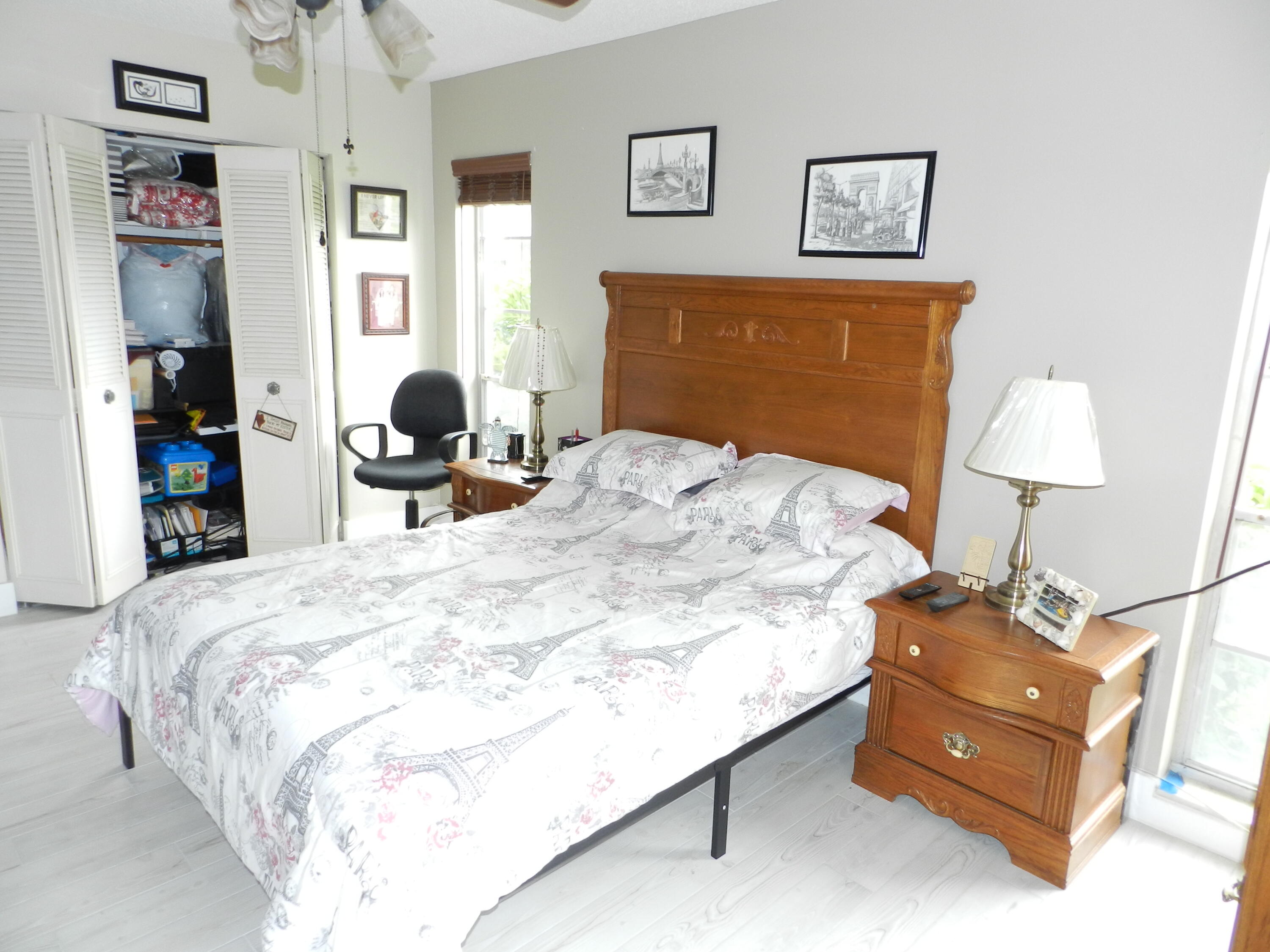 7 Greenway Village North, Unit 103 Royal Palm Beach, FL 33411 - Photo 16 of 29 a bedroom with a bed and wooden floor