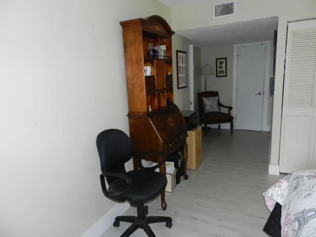 a view of a workspace with furniture and lounge chair