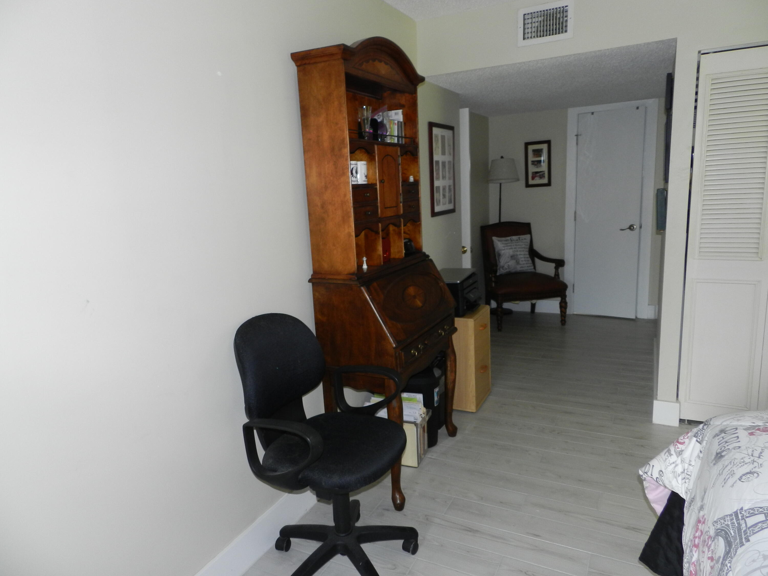 7 Greenway Village North, Unit 103 Royal Palm Beach, FL 33411 - Photo 18 of 29 a view of a workspace with furniture and lounge chair