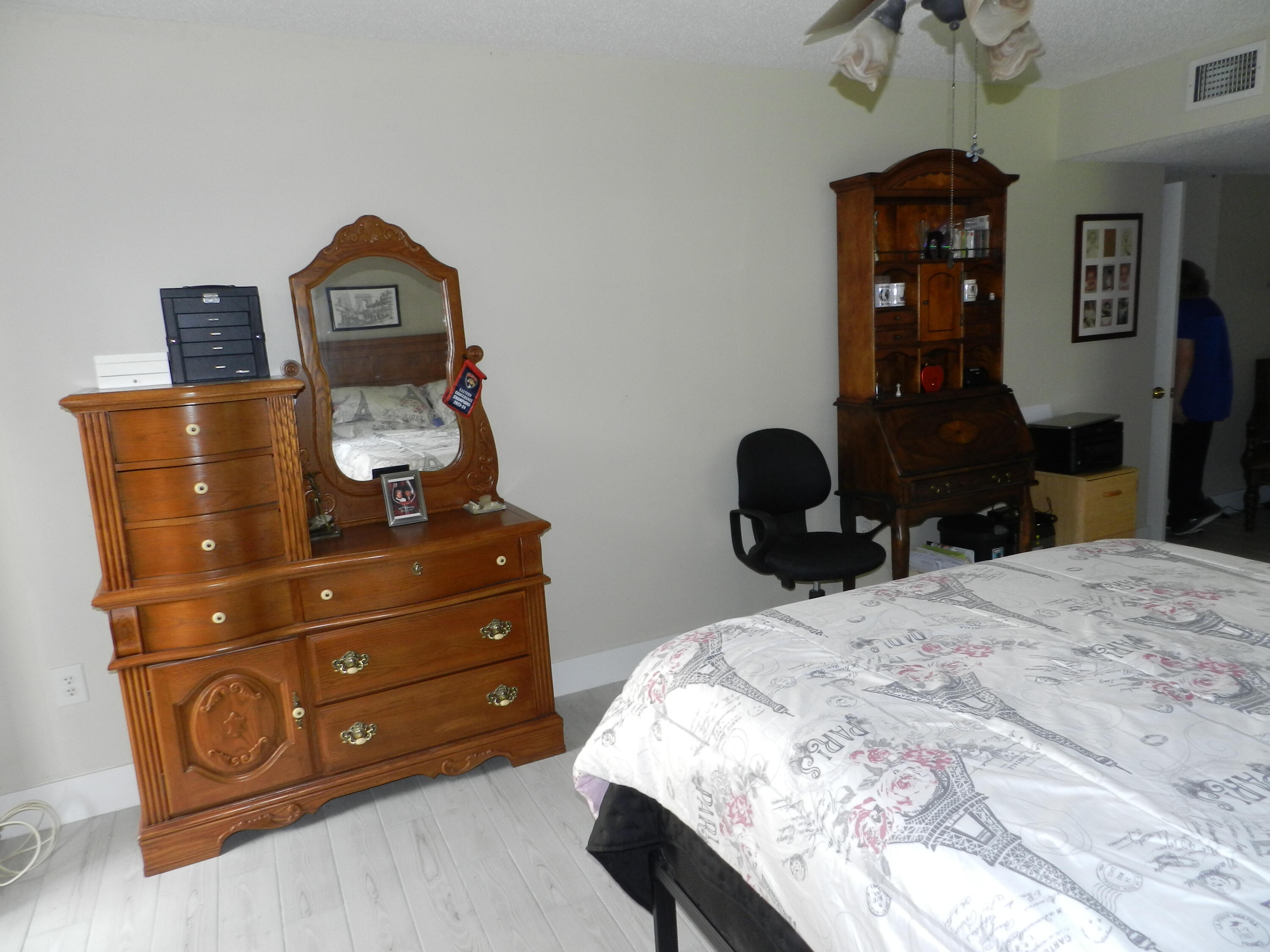 7 Greenway Village North, Unit 103 Royal Palm Beach, FL 33411 - Photo 20 of 29 a bedroom with a bed window and a dresser