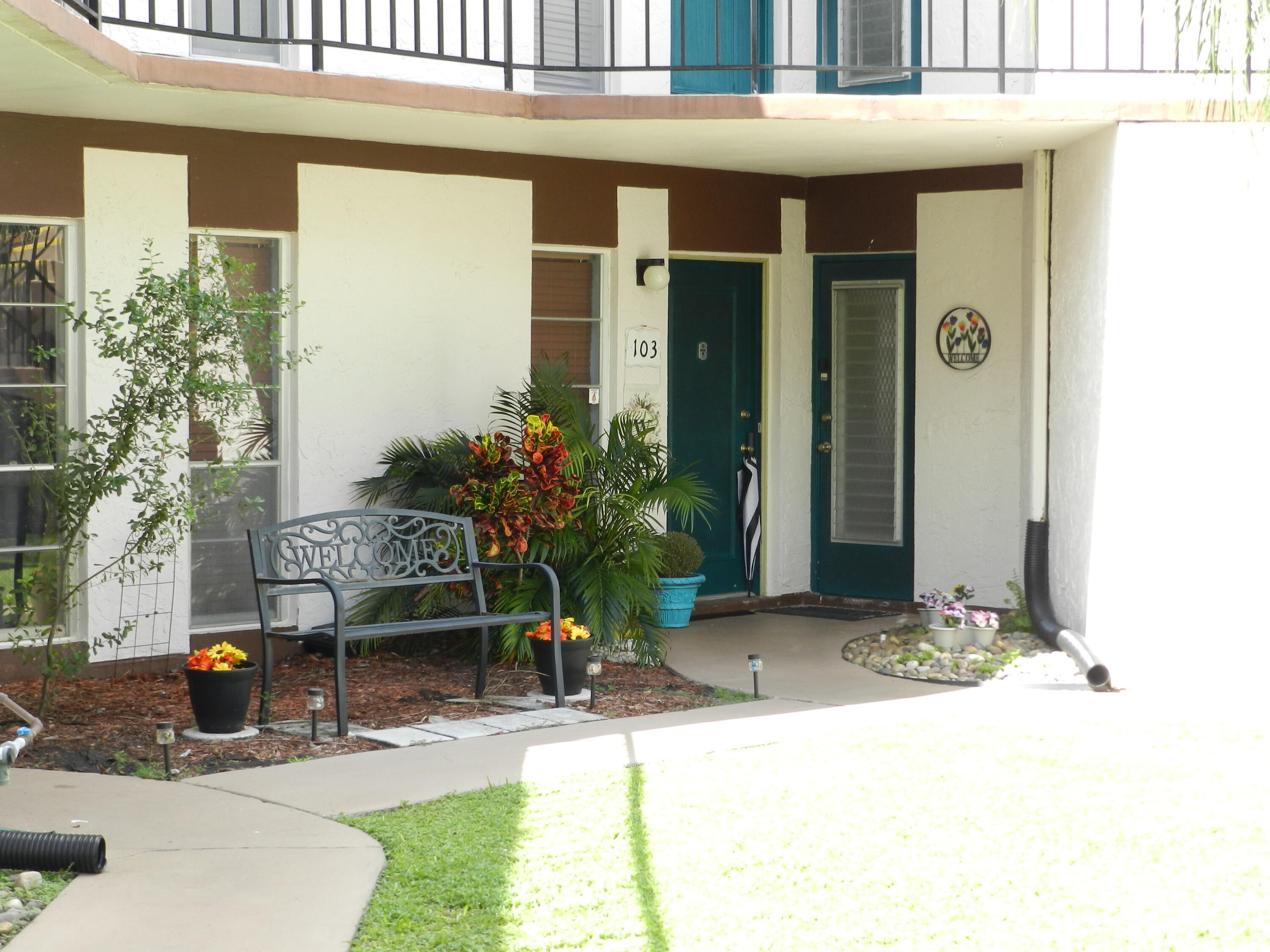 7 Greenway Village North, Unit 103 Royal Palm Beach, FL 33411 - Photo 2 of 29 a view of outdoor space and porch