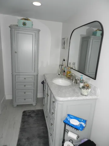 a bathroom with a sink a vanity and a mirror