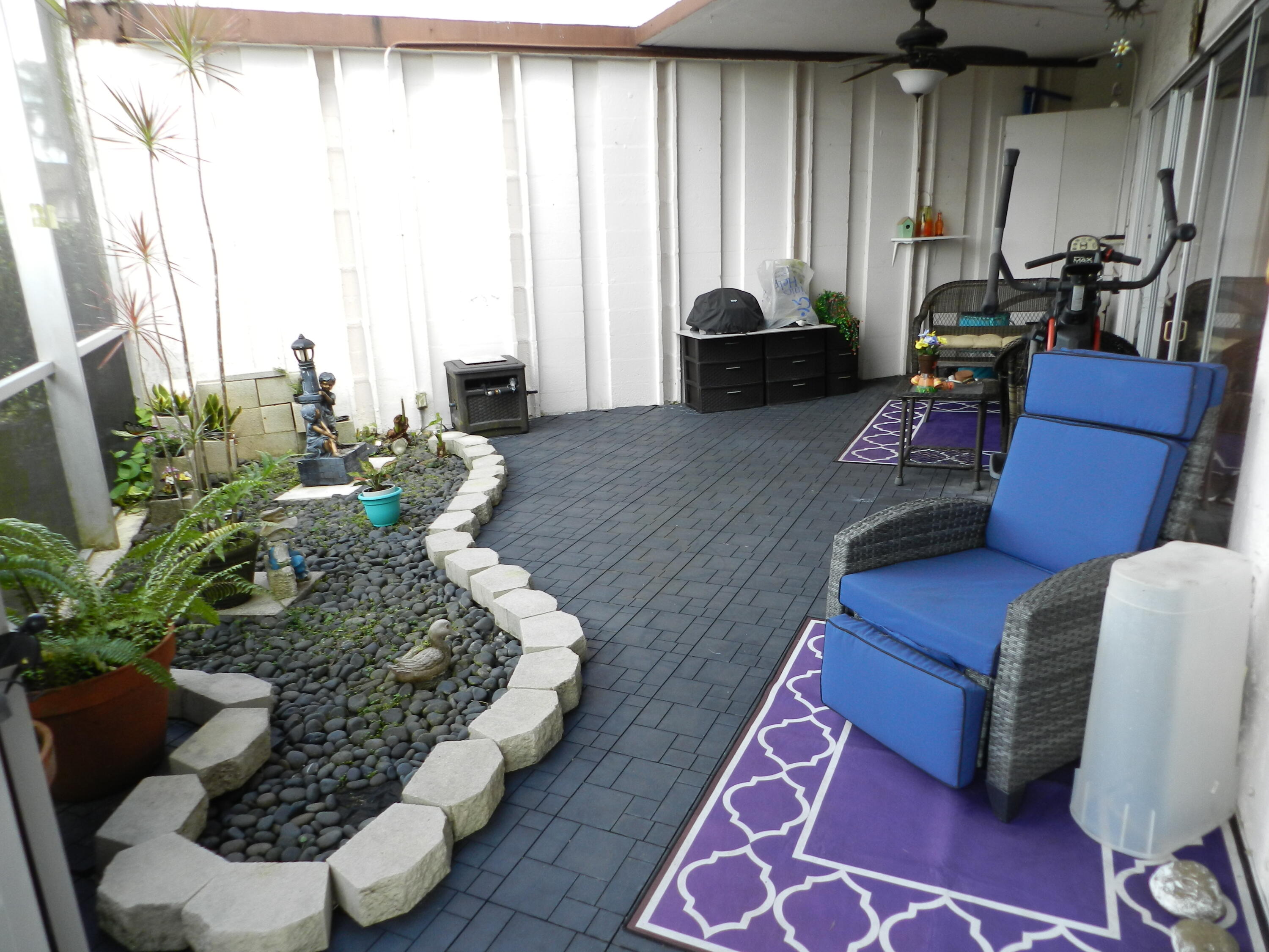 7 Greenway Village North, Unit 103 Royal Palm Beach, FL 33411 - Photo 29 of 29 a living room with furniture fireplace and a large window