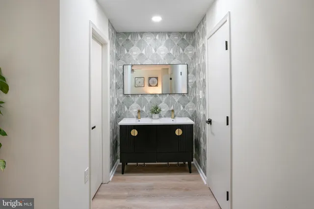 a view of bathroom with a sink and a mirror