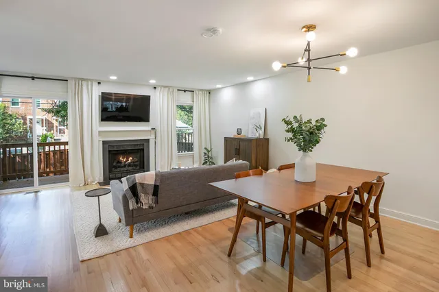 a view of a dining room with furniture wooden floor and chandelier