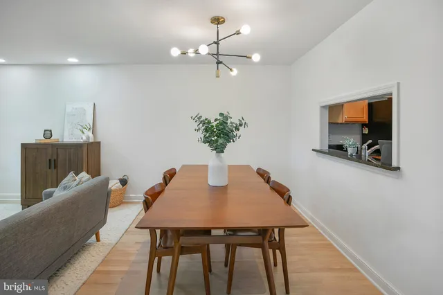 a dining room with furniture and chandelier