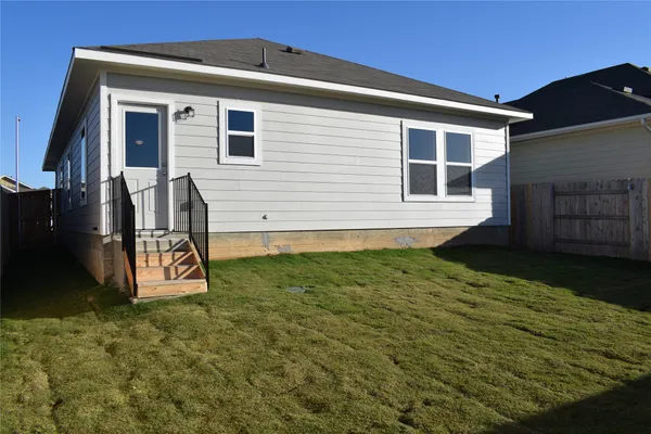 a view of a backyard of the house