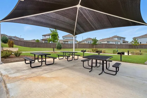 a sign that is sitting in the grass next to a building