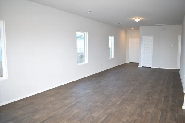 a kitchen with a refrigerator stove and white cabinets