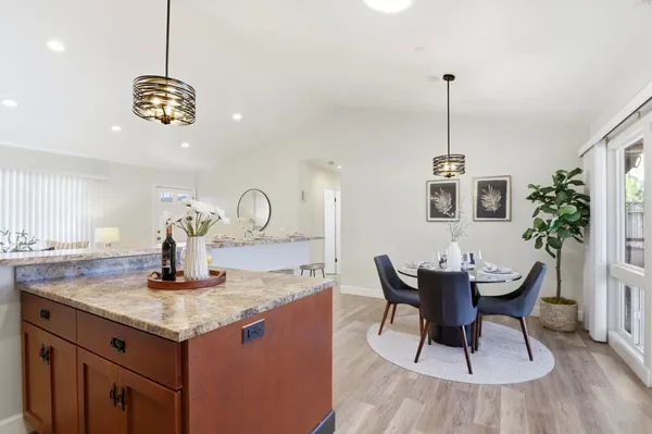 a kitchen with a table chairs and chandelier