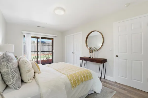 a bedroom with a bed and wooden floor