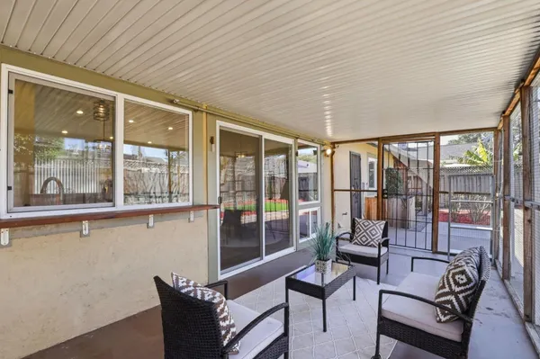 a living room with furniture and a floor to ceiling window