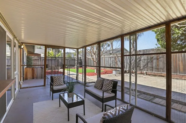 a view of a house with backyard and a tree