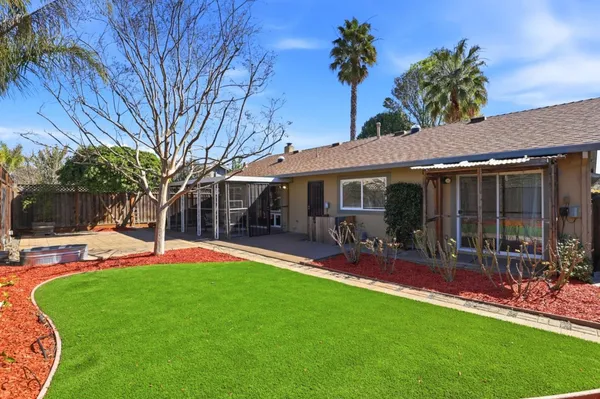 a view of a pathway with a wrought fence