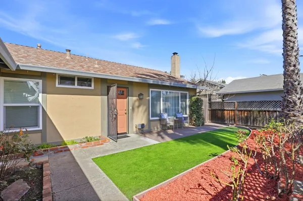 a front view of a house with a garden and patio