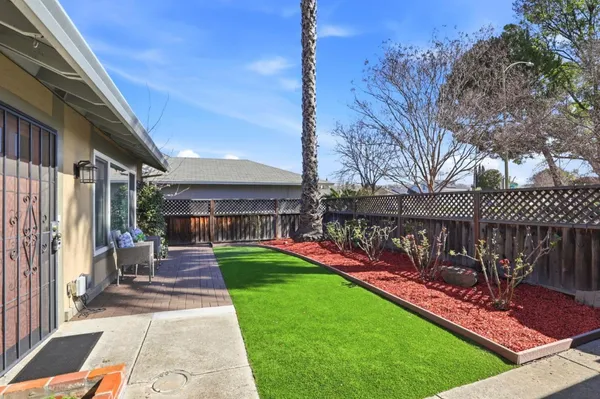 a view of a chair and tables in the patio