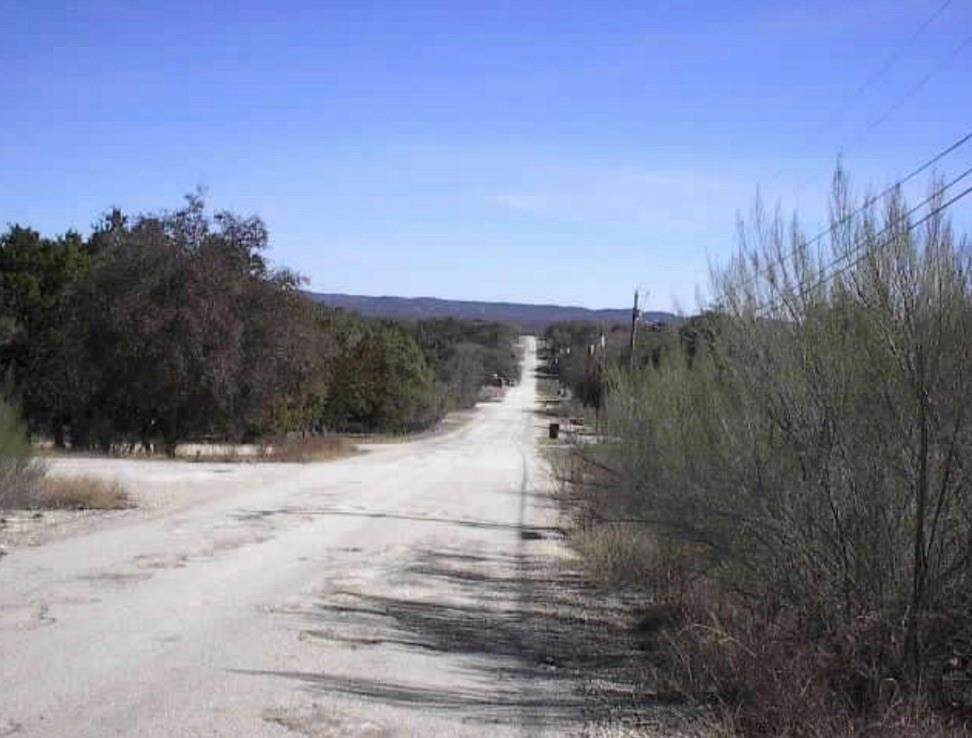 829 Tejas Trail Bandera, TX 78003 - Photo 5 of 6 a view of a yard with mountain