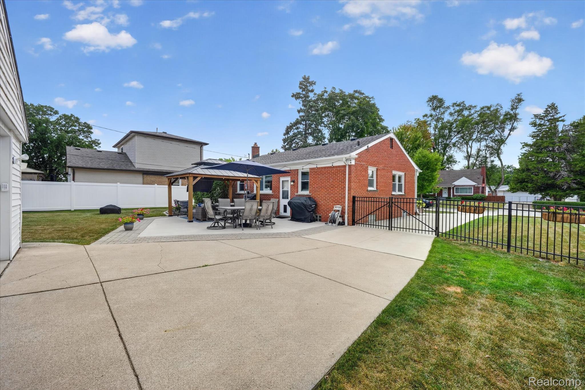 4112 Durham Road Royal Oak, MI 48073 - Photo 33 of 38 Expansive concrete patio with paver accents and a dedicated shaded area