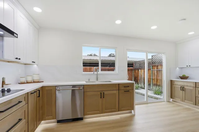 a kitchen with a sink stove and cabinets