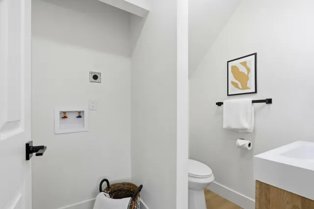 a white toilet sitting next to a bathroom sink