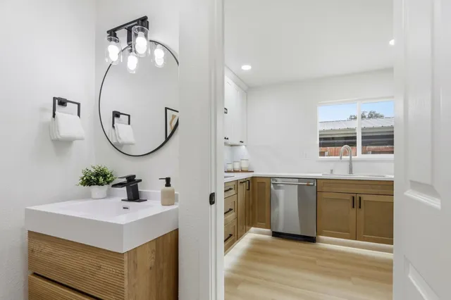 a spacious bathroom with a sink a mirror and a window