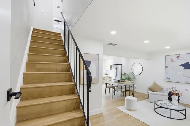 a view of entryway and hall with wooden floor