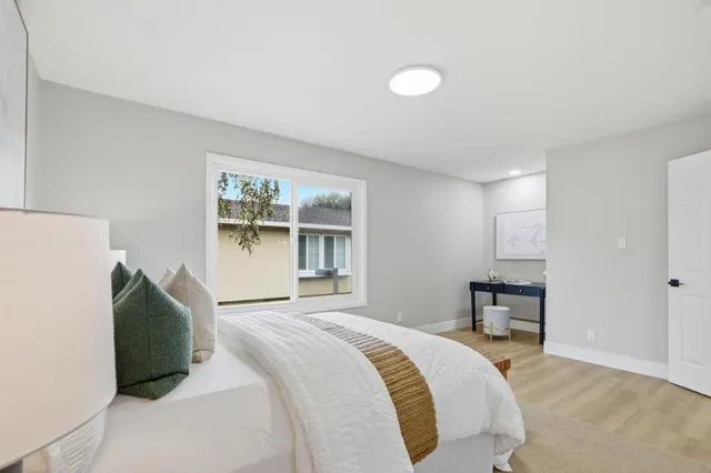 a bedroom with a bed and a window