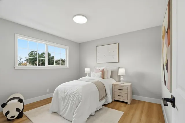 a bedroom with a bed and a window