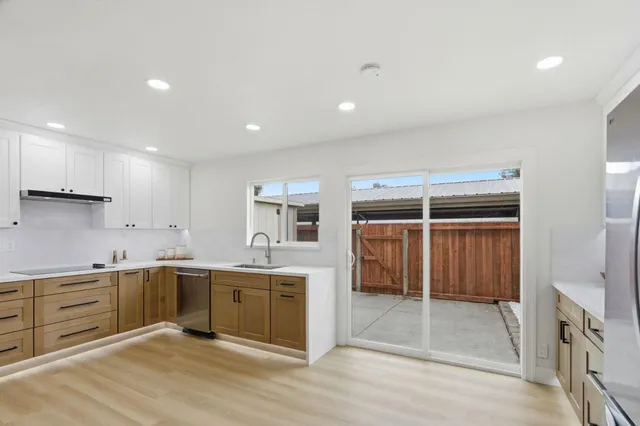 a kitchen with a sink stove and cabinets