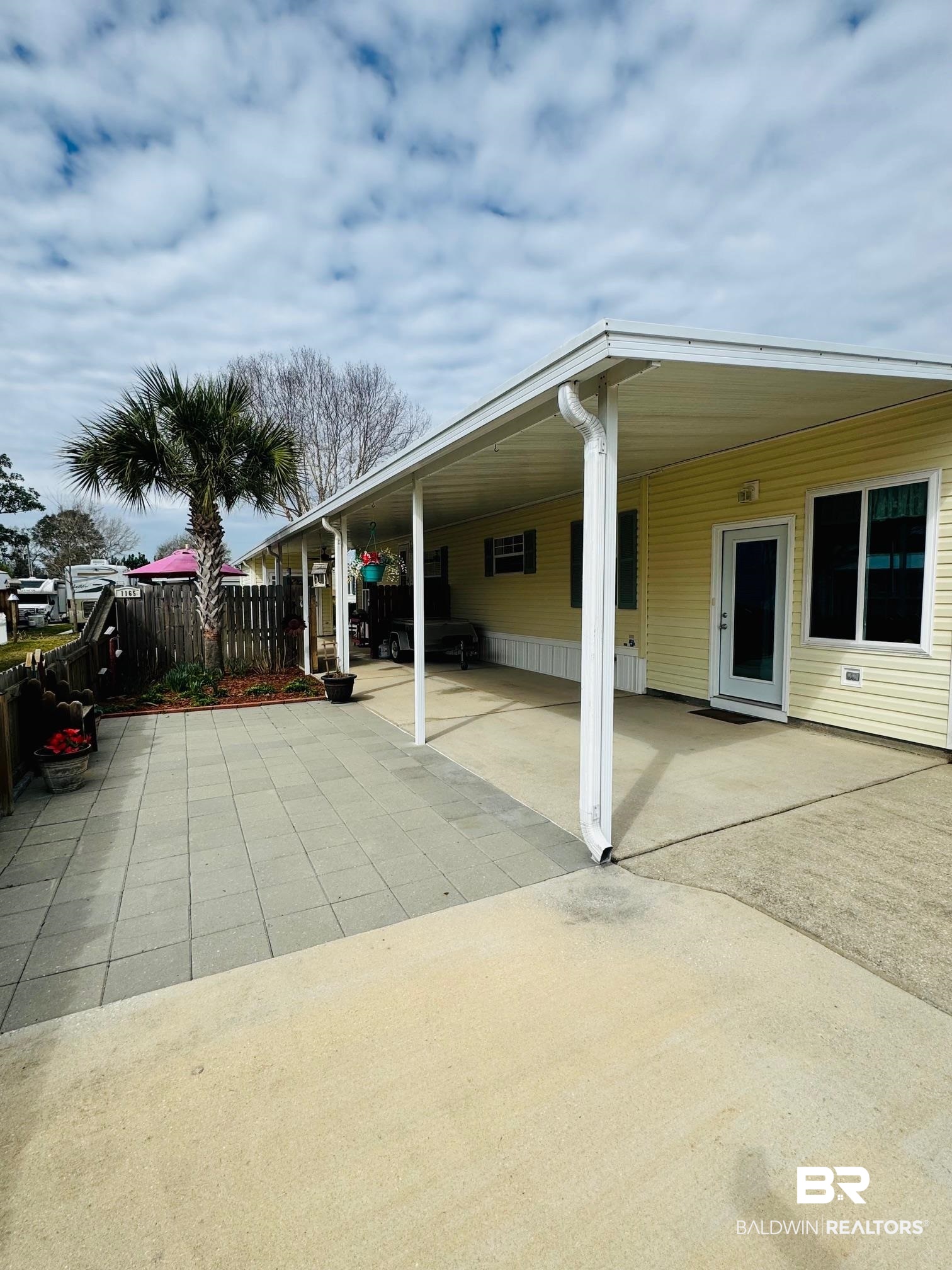 1165 Santa Anna Lane Lillian, AL 36549 - Photo 21 of 43 View of patio / terrace with a carport and fence