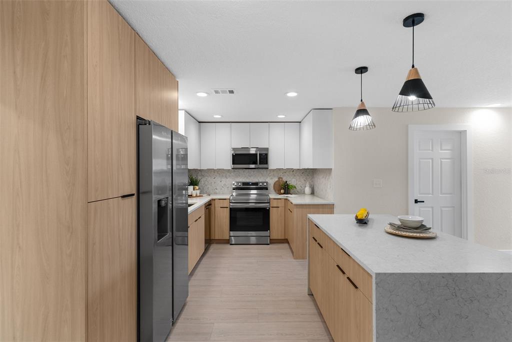 12368 70th Street Largo, FL 33773 - Photo 12 of 33 a kitchen with stainless steel appliances a sink stove and refrigerator