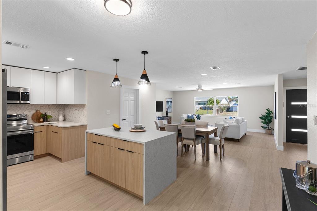 12368 70th Street Largo, FL 33773 - Photo 14 of 33 a kitchen with a sink stove and wooden cabinets