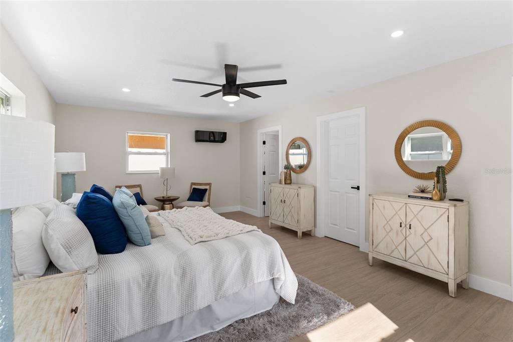 12368 70th Street Largo, FL 33773 - Photo 16 of 33 a bed room with a bed mirror and a window