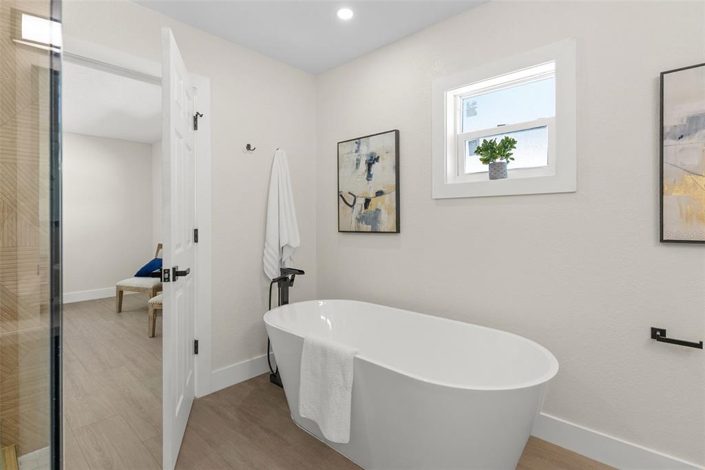 12368 70th Street Largo, FL 33773 - Photo 20 of 33 a white tub sitting next to a bathroom