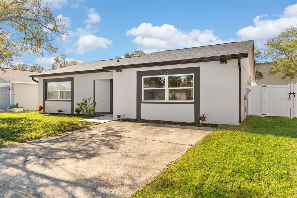 12368 70th Street Largo, FL 33773 - Photo 2 of 33 a view of a house with backyard and garden