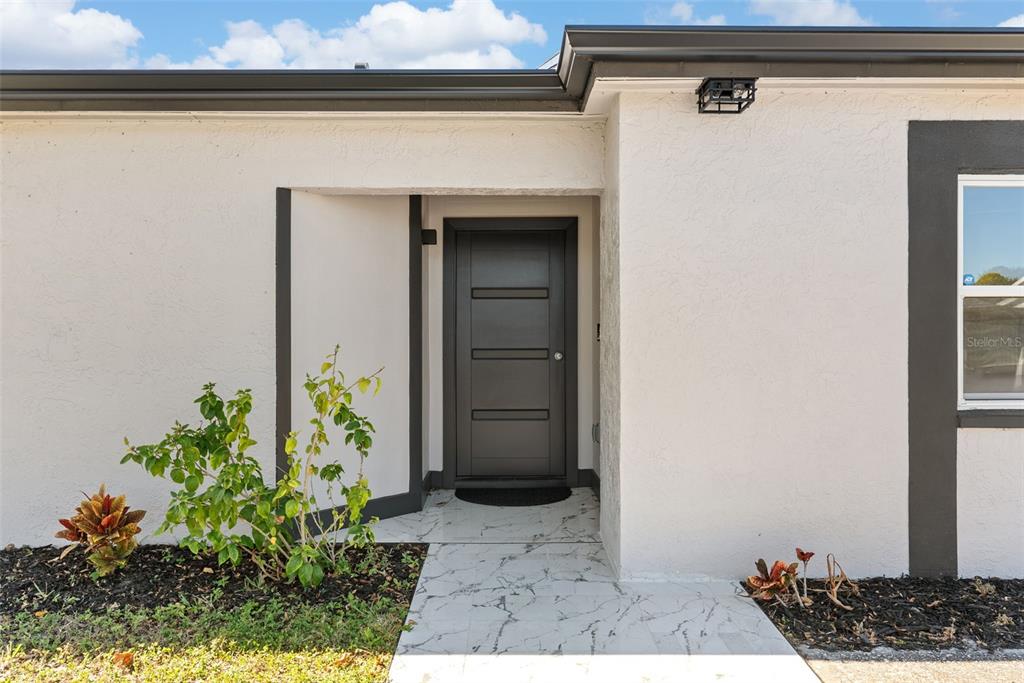 12368 70th Street Largo, FL 33773 - Photo 4 of 33 a view of a door and a window of the house