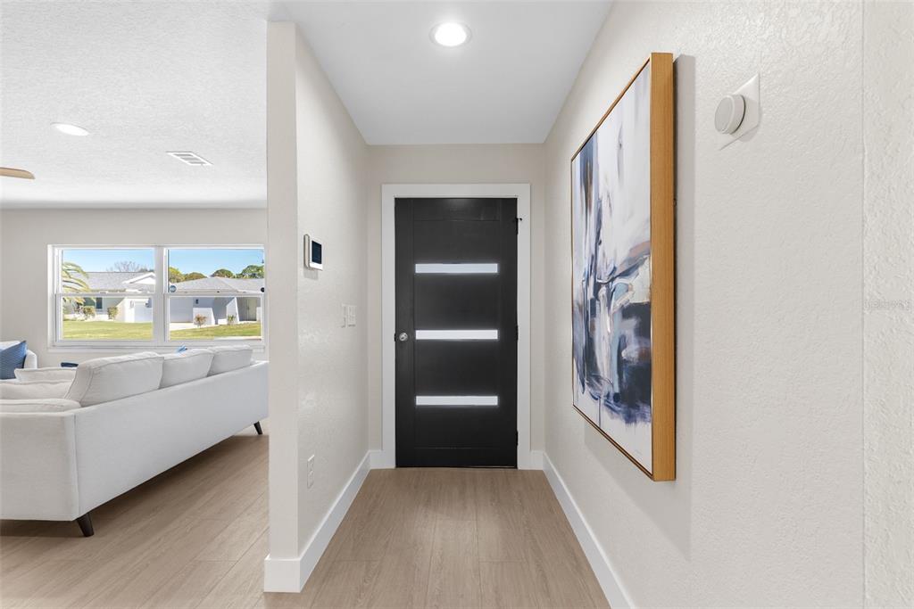 12368 70th Street Largo, FL 33773 - Photo 5 of 33 a view of hallway with furniture and wooden floor