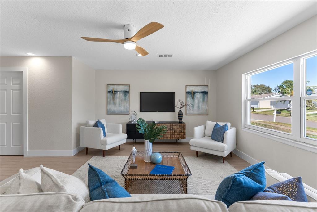 12368 70th Street Largo, FL 33773 - Photo 7 of 33 a living room with furniture and a flat screen tv