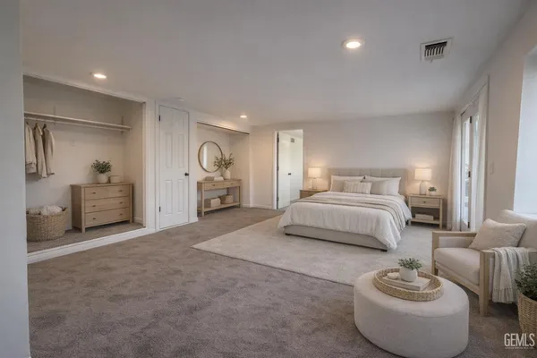 a spacious bedroom with a bed and a mirror