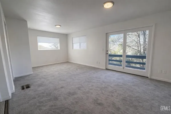 a bathroom with a granite countertop sink mirror and a bath tub