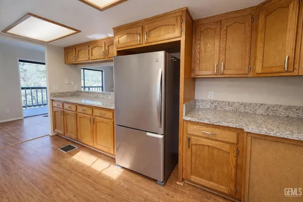 a kitchen with a refrigerator sink and cabinets