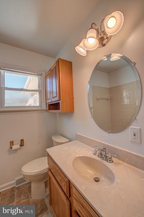 10605 Willetts Crossing Road White Plains, MD 20695 - Photo 14 of 22 a bathroom with a sink a toilet and a mirror