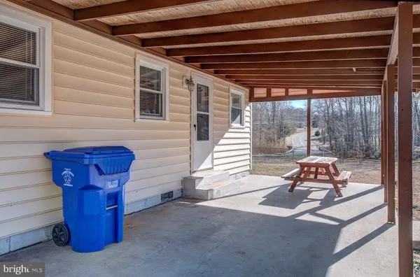 a view of dirt yard with trees