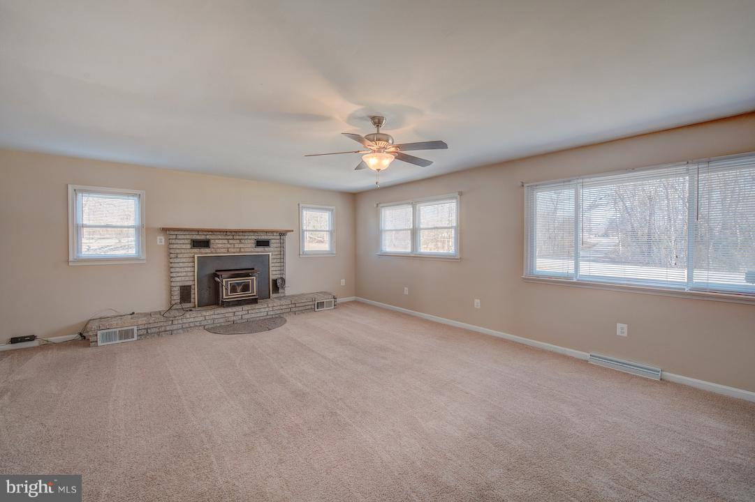 10605 Willetts Crossing Road White Plains, MD 20695 - Photo 5 of 22 an empty room with windows and fireplace