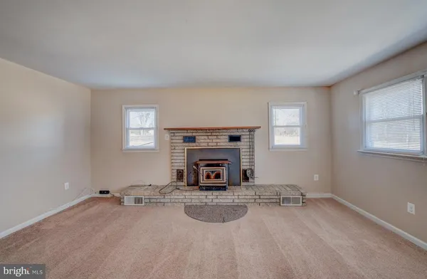 wooden floor and fireplace in empty room