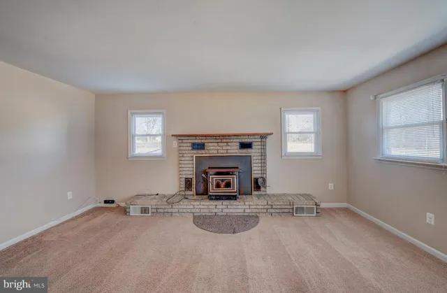 wooden floor and fireplace in empty room