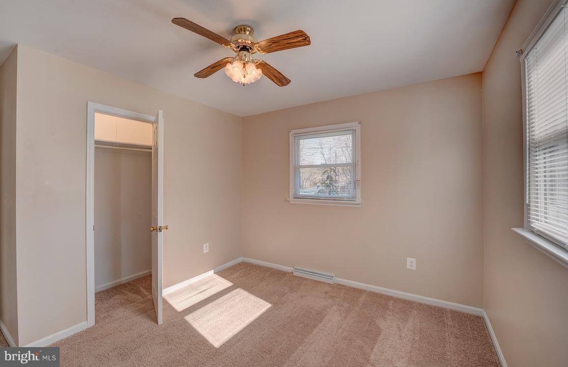 10605 Willetts Crossing Road White Plains, MD 20695 - Photo 7 of 22 an empty room with a window and a ceiling fan